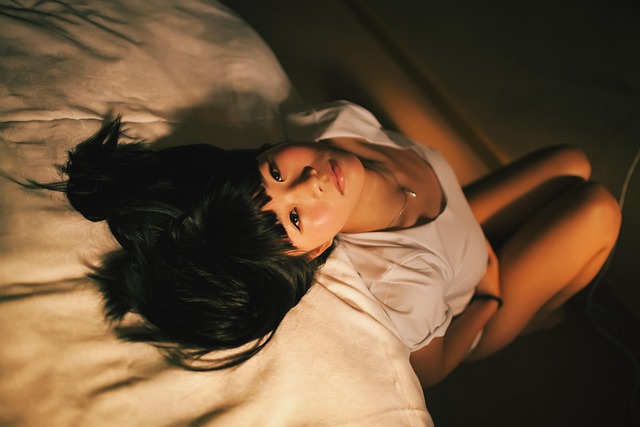 快適な寝室で目覚め、笑顔で伸びをする人